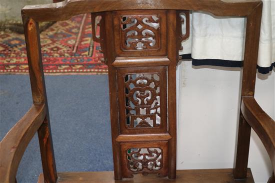 A pair of Chinese carved hardwood elbow chairs